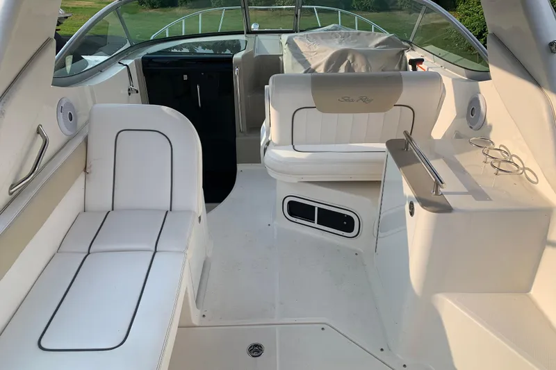 Slide: The Image of 2010 Sea Ray 260 Sundancer interior with white seating and modern design. - 24