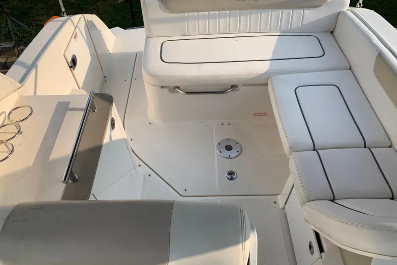 Slide: The Image of 2010 Sea Ray 260 Sundancer boat interior with white seating and stainless steel railings. - 28