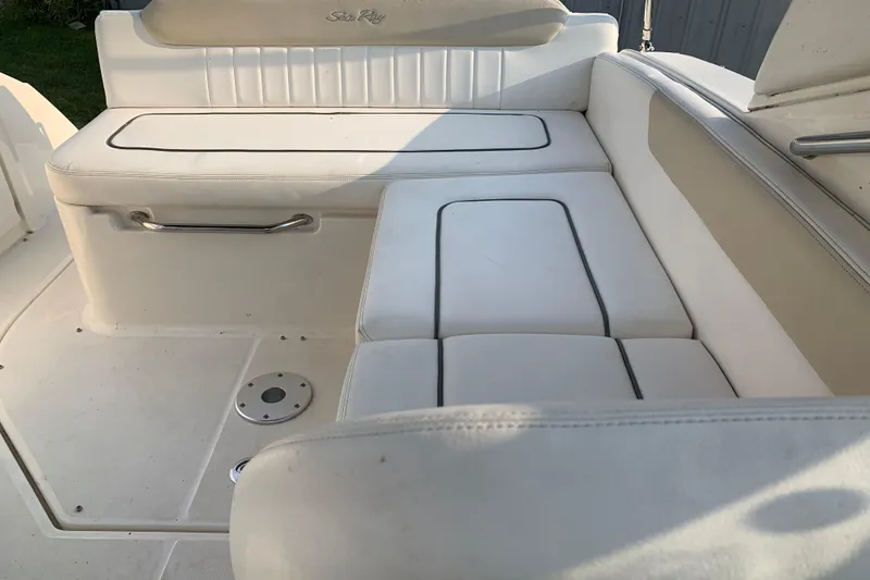 Slide: The Image of 2010 Sea Ray 260 Sundancer boat interior with white cushioned seating. - 30