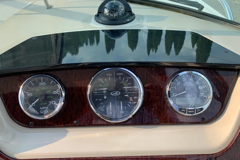 Slide: The Image of Dashboard of a 2010 Sea Ray 260 Sundancer boat with gauges and compass. - 34