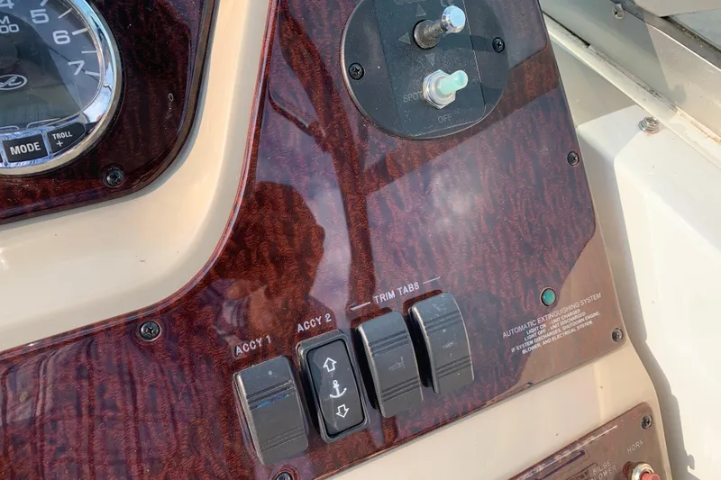 Slide: The Image of Control panel of a 2010 Sea Ray 260 Sundancer boat with switches and gauges. - 35