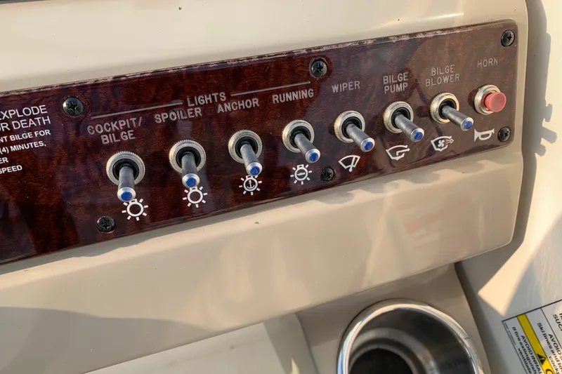 Slide: The Image of Control panel of a 2010 Sea Ray 260 Sundancer boat with various switches. - 36