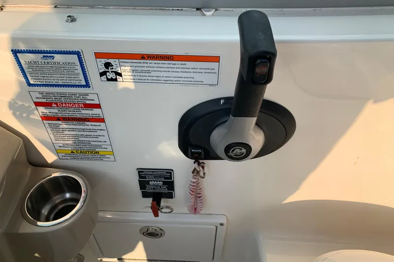 Slide: The Image of Control panel of a 2010 Sea Ray 260 Sundancer boat with safety warnings. - 38