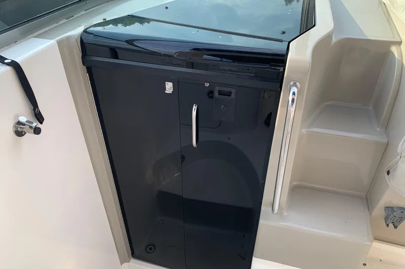 Slide: The Image of 2010 Sea Ray 260 Sundancer boat interior with black cabinet and steps. - 39