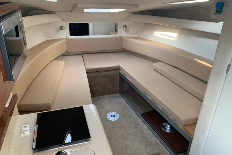 Slide: The Image of 2010 Sea Ray 260 Sundancer cabin interior with beige seating and kitchenette. - 41