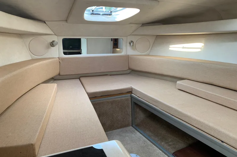 Slide: The Image of Interior of 2010 Sea Ray 260 Sundancer boat with beige seating and skylight. - 42