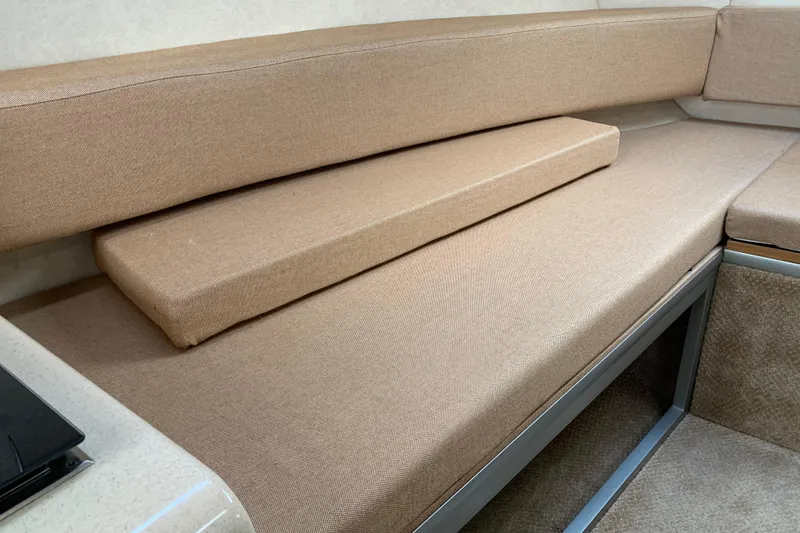 Slide: The Image of Interior seating of 2010 Sea Ray 260 Sundancer with beige upholstery. - 43