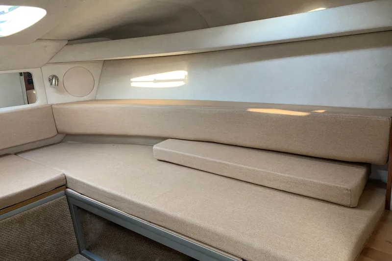 Slide: The Image of Interior cabin of 2010 Sea Ray 260 Sundancer with beige seating and natural light. - 44