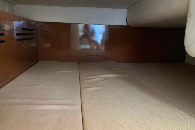 Slide: The Image of Interior cabin of 2010 Sea Ray 260 Sundancer with beige cushions and wooden paneling. - 50