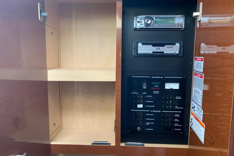 Slide: The Image of Control panel and stereo system inside a 2010 Sea Ray 260 Sundancer boat. - 52