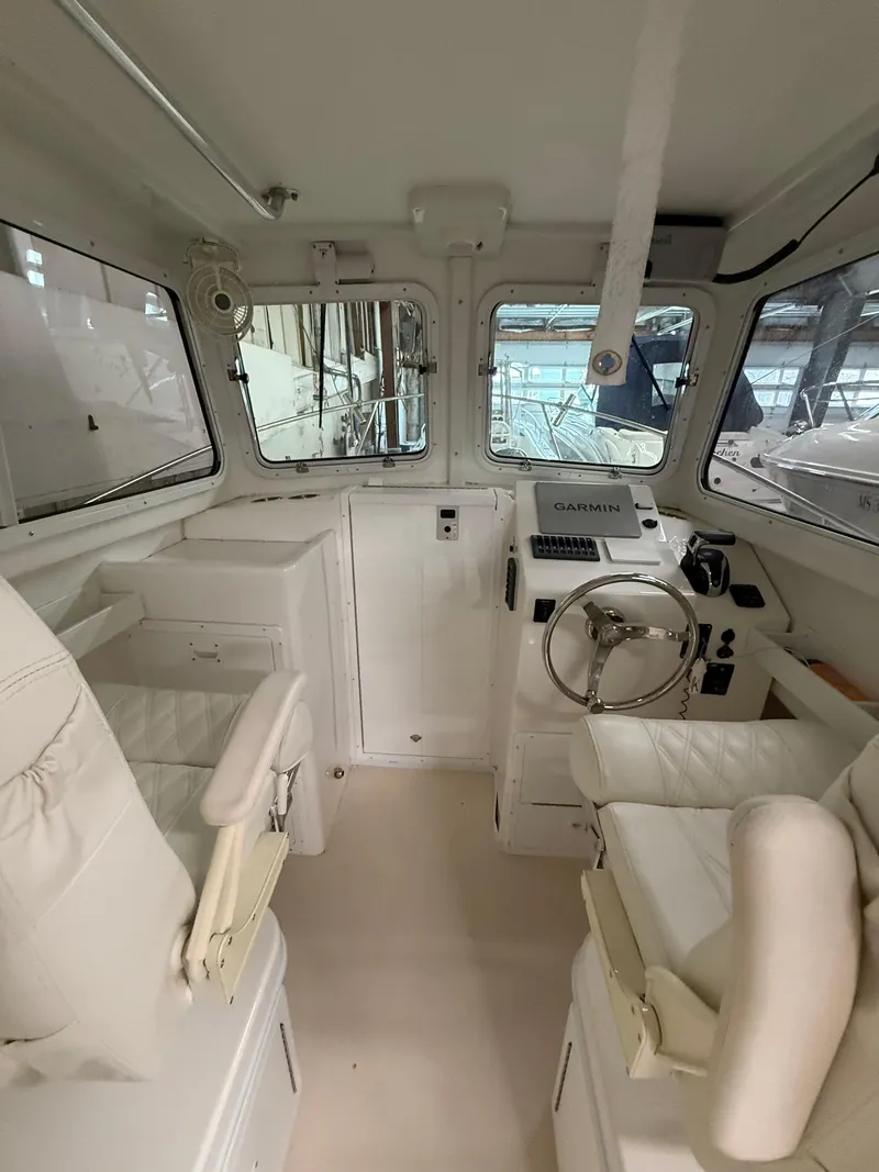 Slide: The Image of Interior of 2021 Steiger Craft 23DV Miami boat with steering wheel and seating. - 10