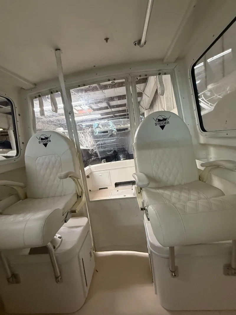 Slide: The Image of Interior of 2021 Steiger Craft 23DV Miami boat with two white seats. - 11
