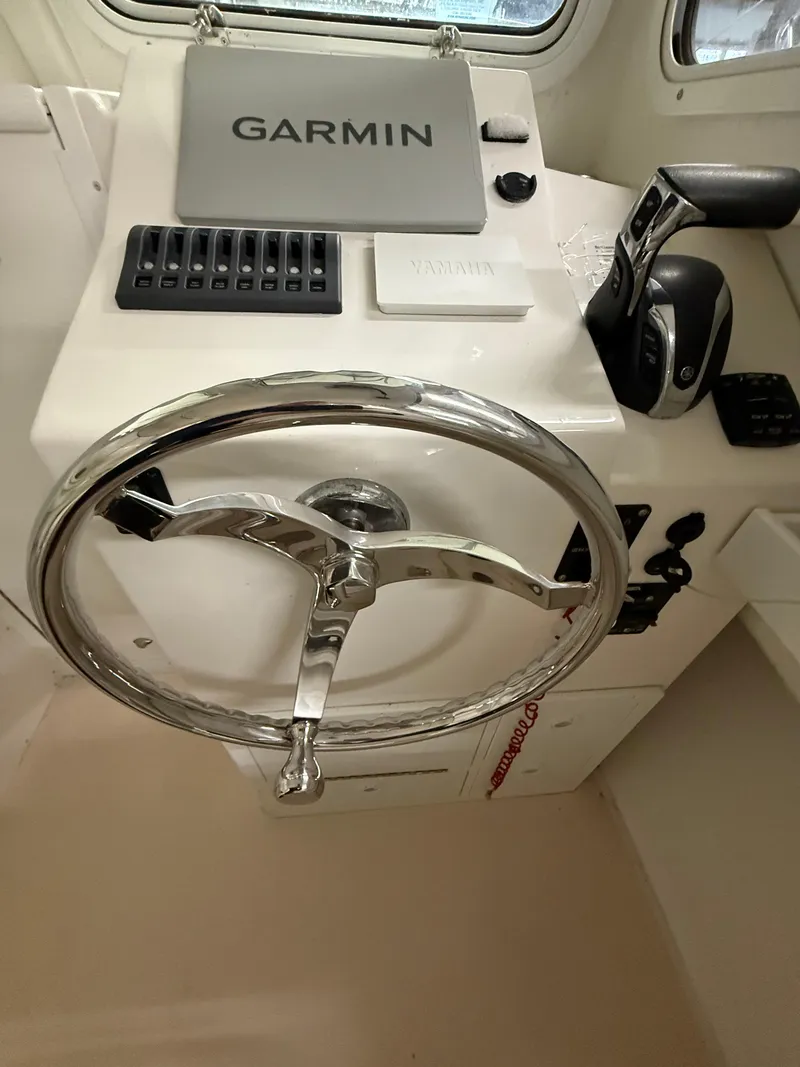 Slide: The Image of Steiger Craft 23DV Miami 2021 helm with Garmin navigation and steering wheel. - 13