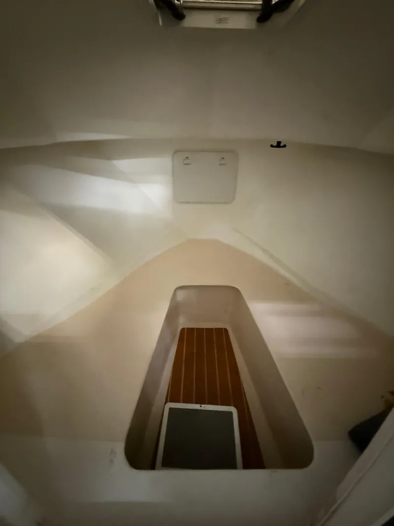 Slide: The Image of Interior cabin of 2021 Steiger Craft 23DV Miami boat, featuring a compact, minimalist design. - 14