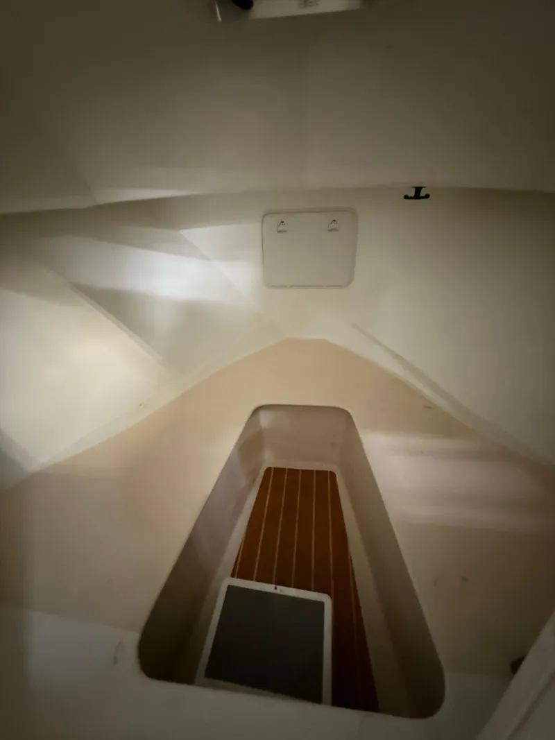 Slide: The Image of Interior cabin of 2021 Steiger Craft 23DV Miami boat, featuring a wooden floor. - 15