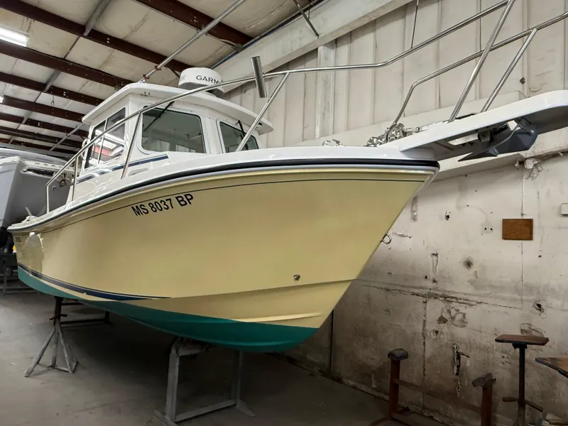 Slide: The Image of 2021 Steiger Craft 23DV Miami boat in indoor storage, yellow hull, side view. - 2