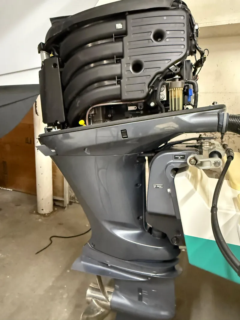 Slide: The Image of 2021 Steiger Craft 23DV Miami outboard motor, detailed view in a garage setting. - 20