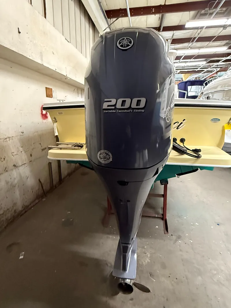 Slide: The Image of Outboard motor on a 2021 Steiger Craft 23DV Miami boat in a garage setting. - 6