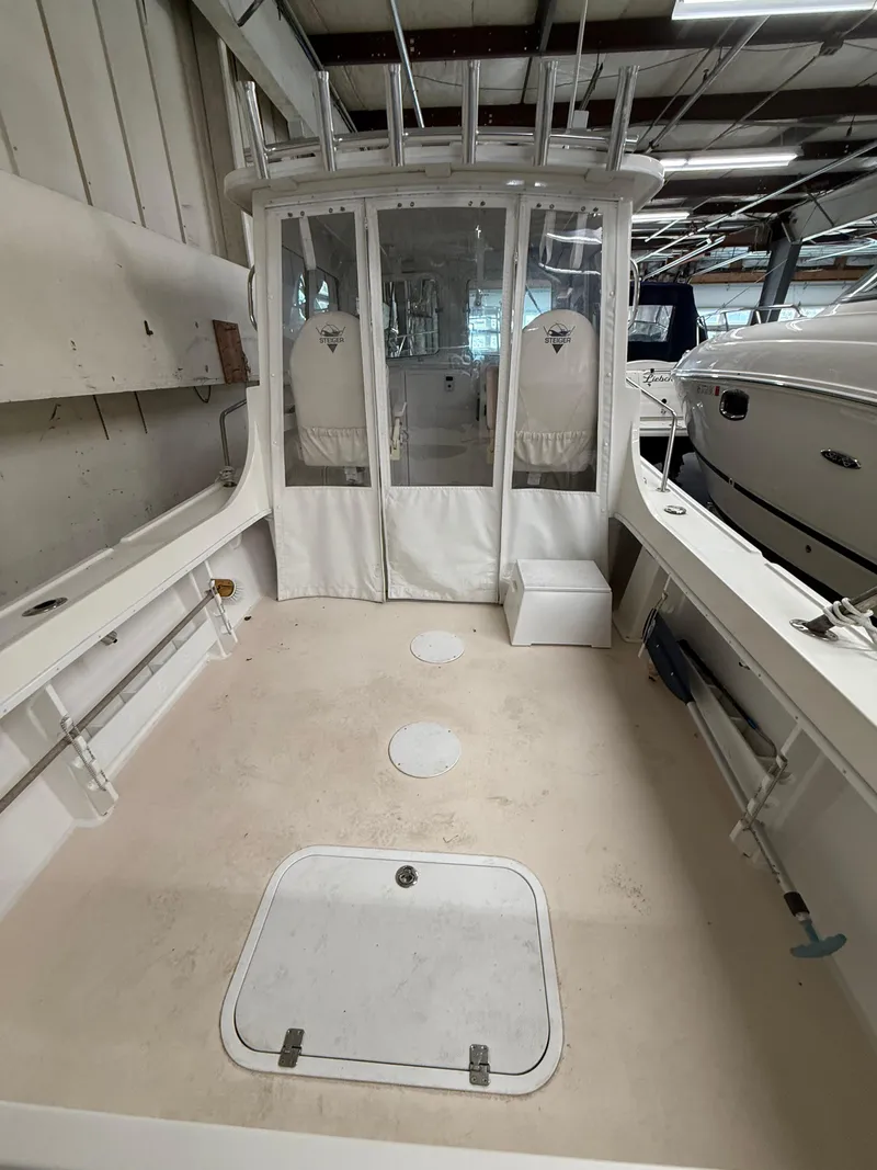 Slide: The Image of 2021 Steiger Craft 23DV Miami boat interior, spacious deck, and storage compartments. - 8