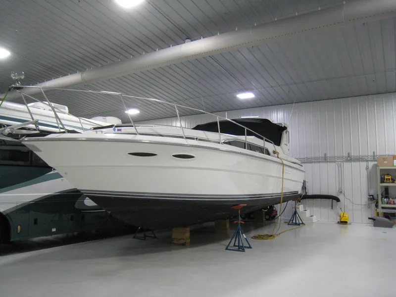 The Image of 1986 Sea Ray 340 Express Cruiser in indoor storage facility. - 1