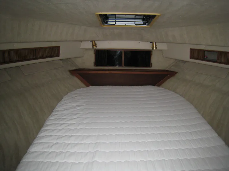 Slide: The Image of Interior cabin of 1986 Sea Ray 340 Express Cruiser with bed and window. - 11