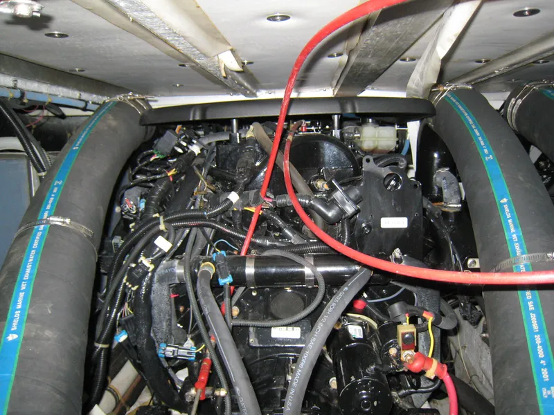 Slide: The Image of Engine compartment of a 1986 Sea Ray 340 Express Cruiser with visible hoses and wiring. - 16