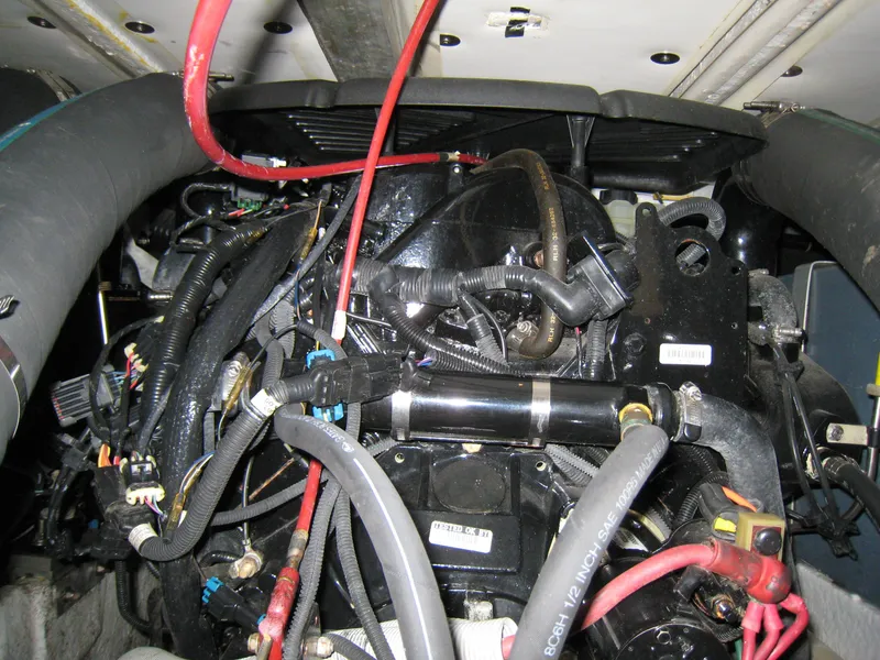 Slide: The Image of Engine compartment of a 1986 Sea Ray 340 Express Cruiser with visible wiring and hoses. - 17