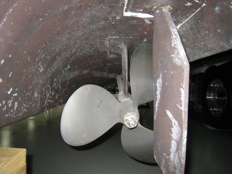 Slide: The Image of Propeller and rudder of 1986 Sea Ray 340 Express Cruiser, showing wear and marine growth. - 19