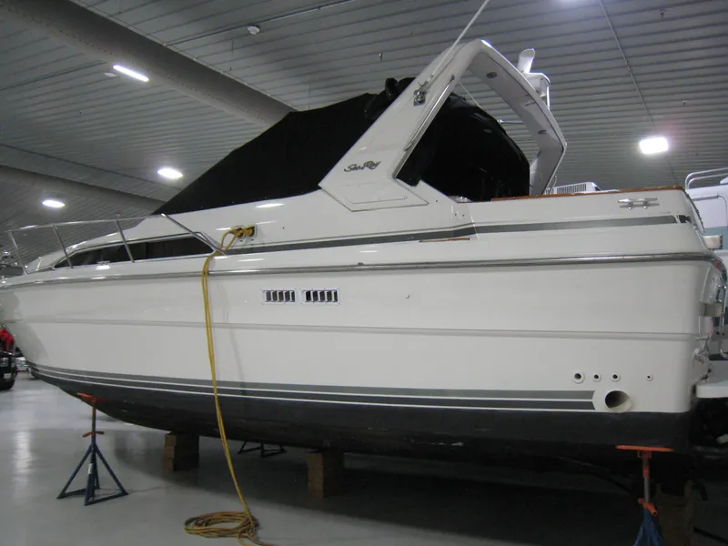 Slide: The Image of 1986 Sea Ray 340 Express Cruiser in indoor storage, side view. - 3