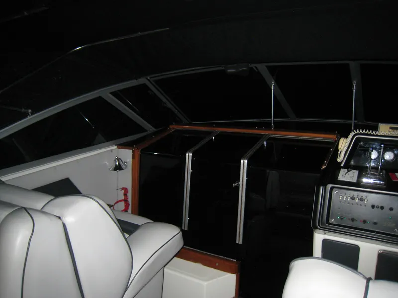 Slide: The Image of 1986 Sea Ray 340 Express Cruiser interior with helm and seating area. - 9