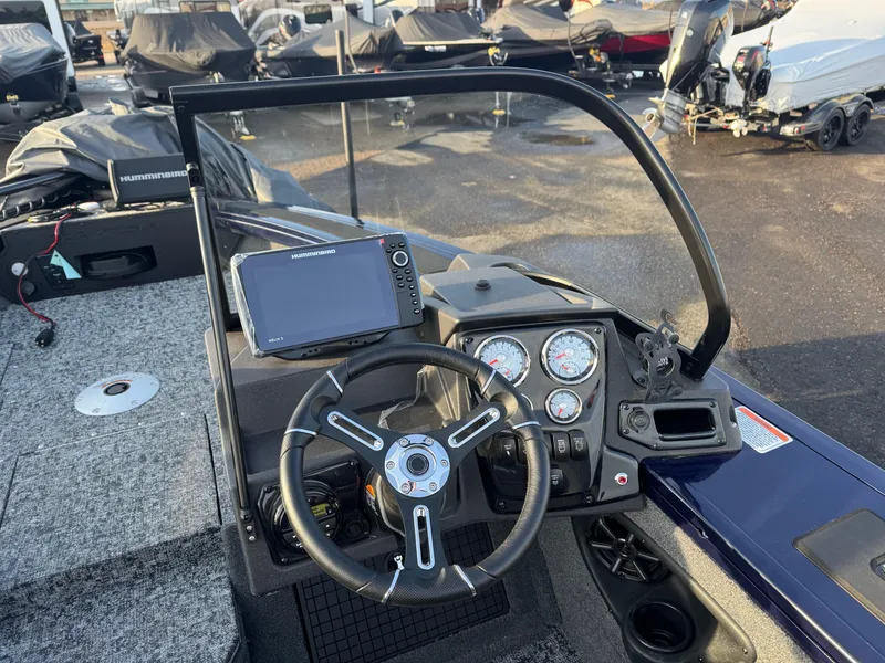 Slide: The Image of 2024 Tracker Targa V-19 WT boat dashboard with steering wheel and navigation system. - 10