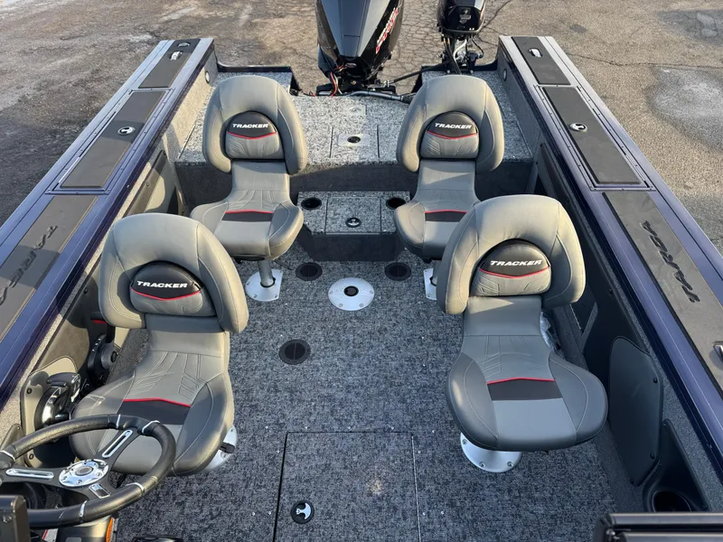 Slide: The Image of 2024 Tracker Targa V-19 WT boat interior with four seats and steering wheel. - 13