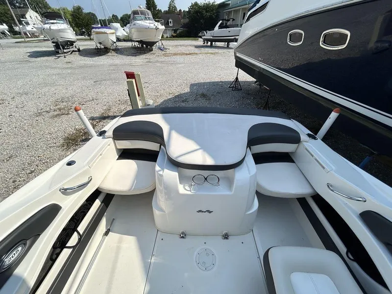 Slide: The Image of Interior of a 2012 Sea Ray 205 Sport boat, featuring seating and storage areas. - 1