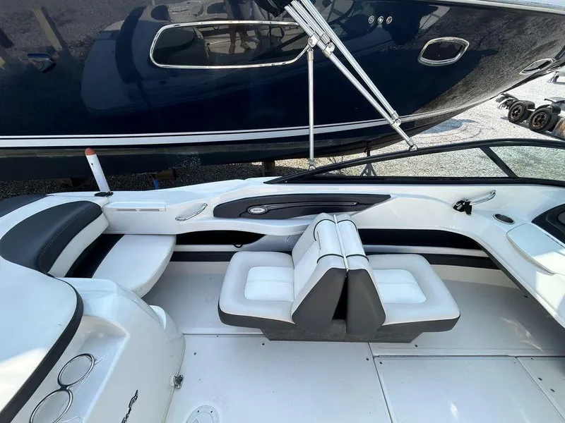 Slide: The Image of 2012 Sea Ray 205 Sport boat interior with white and black seating. - 2