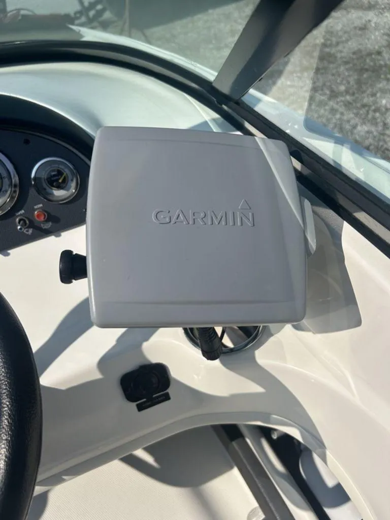 Slide: The Image of Garmin device on 2012 Sea Ray 205 Sport boat dashboard with gauges. - 5