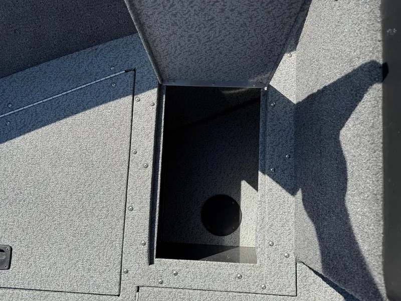 Slide: The Image of 2017 Lund 1650 Rebel XS SS boat storage compartment, open and empty. - 13