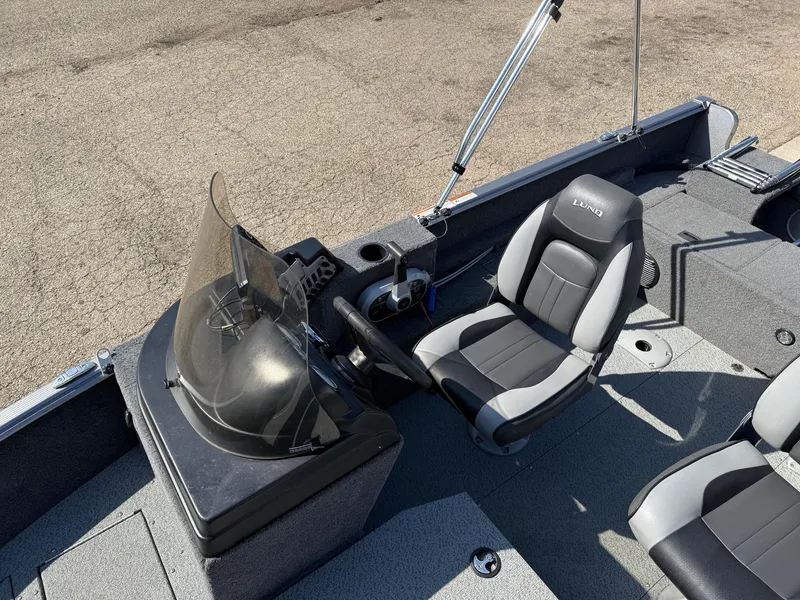 Slide: The Image of 2017 Lund 1650 Rebel XS SS boat interior with steering console and seating. - 17