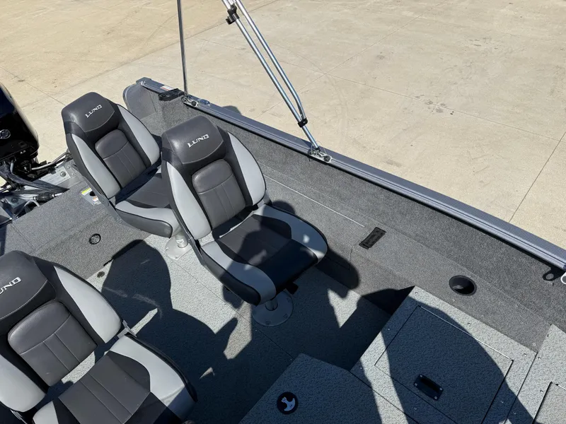 Slide: The Image of 2017 Lund 1650 Rebel XS SS boat interior with two gray and black seats. - 18