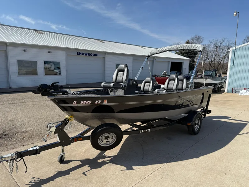 Slide: The Image of 2017 Lund 1650 Rebel XS SS boat on trailer outside showroom. - 2