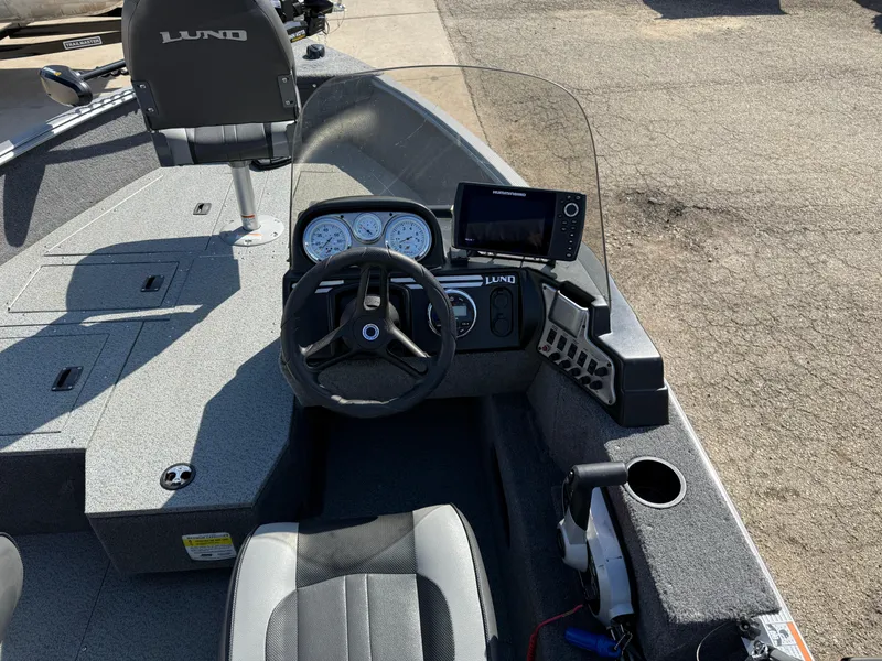 Slide: The Image of 2017 Lund 1650 Rebel XS SS boat interior with steering wheel and dashboard controls. - 21