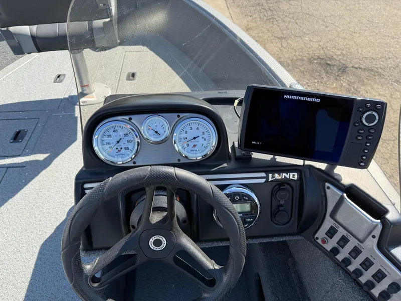 Slide: The Image of 2017 Lund 1650 Rebel XS SS boat dashboard with steering wheel and Humminbird fish finder. - 22