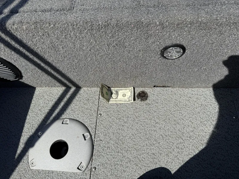 Slide: The Image of 2017 Lund 1650 Rebel XS SS boat interior with dollar bill on carpeted floor. - 30