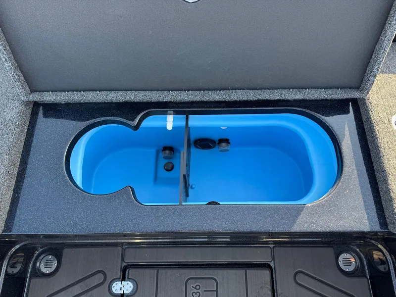 Slide: The Image of 2024 Nitro ZV21 Pro livewell compartment with blue interior, open lid view. - 4