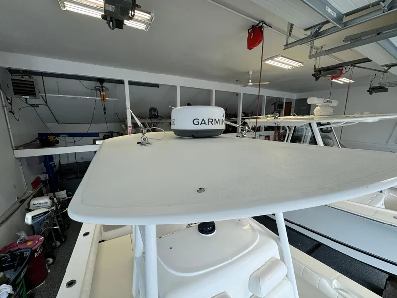 Slide: The Image of 2012 Regulator 24 Forward Seating boat with Garmin radar in a garage. - 12