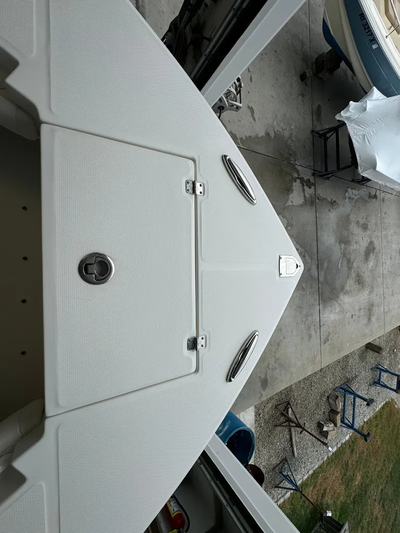 Slide: The Image of 2012 Regulator 24 Forward Seating boat, top view of bow in storage. - 13