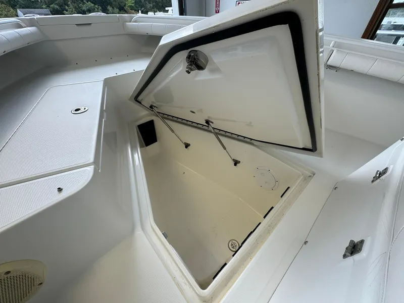 Slide: The Image of 2012 Regulator 24 Forward Seating boat storage compartment open, showcasing interior space. - 14