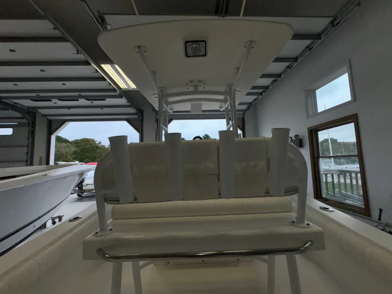 Slide: The Image of 2012 Regulator 24 Forward Seating boat in a garage, rear view. - 21