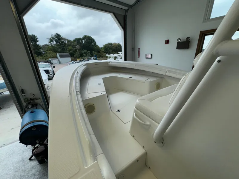 Slide: The Image of 2012 Regulator 24 Forward Seating boat in a garage, showcasing spacious interior design. - 22