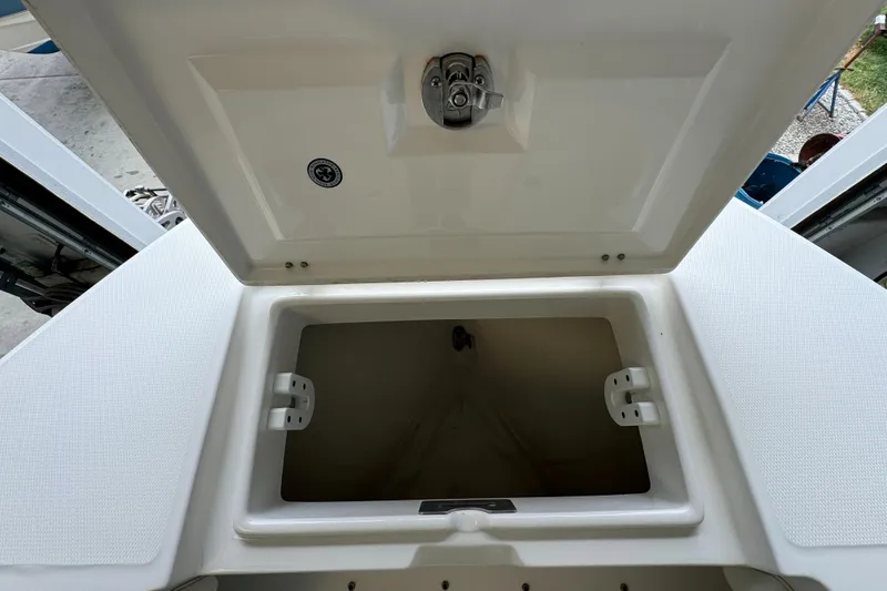 Slide: The Image of Open storage compartment on a 2012 Regulator 24 Forward Seating boat. - 25