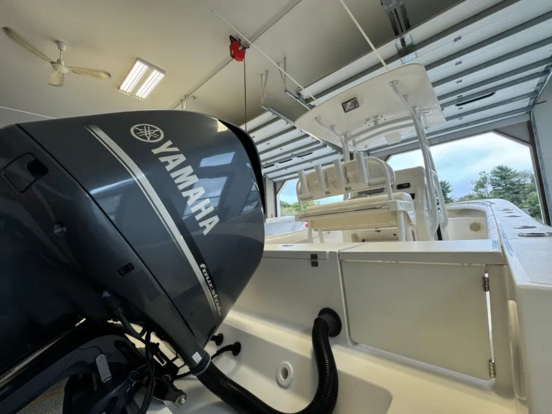 Slide: The Image of 2012 Regulator 24 Forward Seating boat with Yamaha engine in a garage. - 3